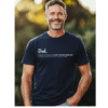 A smiling middle-aged man wearing a dark navy blue t-shirt showing a Dad text design on the front