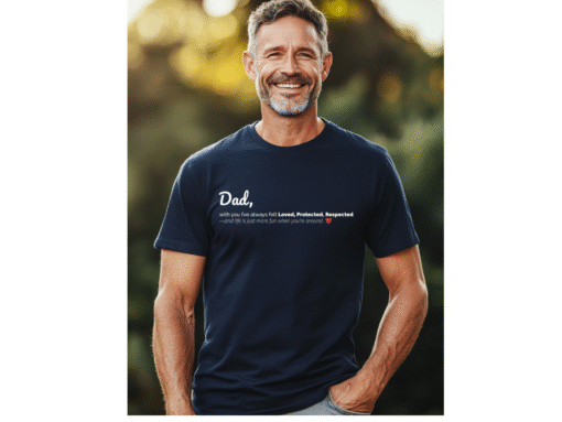 A smiling middle-aged man wearing a dark navy blue t-shirt showing a Dad text design on the front